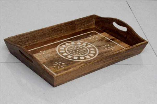 Decorative wooden serving tray with a circular motif and cut-out handles